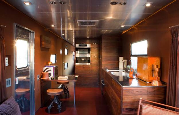 Amenities include a full Miele kitchen and signature Blackman Cruz bronze-and-walnut stools.